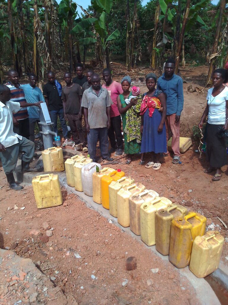 Community members lined up to use the new water well.